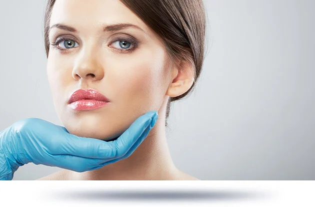 A doctor examining a woman's neck, likely assessing for a neck lift procedure.