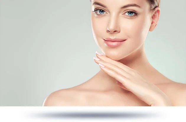 A woman gently touching her chin, showcasing smooth and youthful skin, likely promoting a cosmetic or skincare procedure.