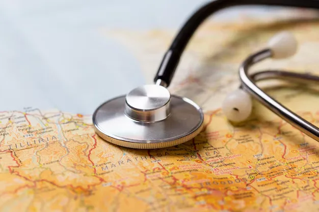A stethoscope is placed on a map, symbolizing medical care or healthcare services in various locations.