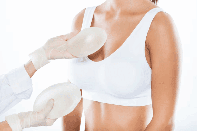 A doctor placing breast implants on a patient's chest.