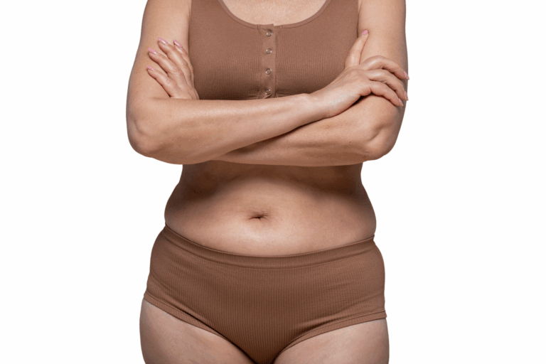 A woman with her arms crossed, showing her stomach and lower body, wearing brown underwear and a matching top.