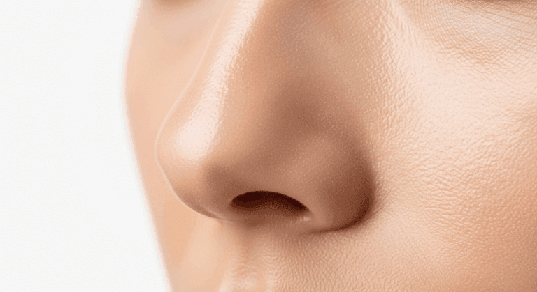 A close-up image of a person's nose, highlighting the detailed texture and structure.